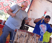 teacher and participant playing large drum